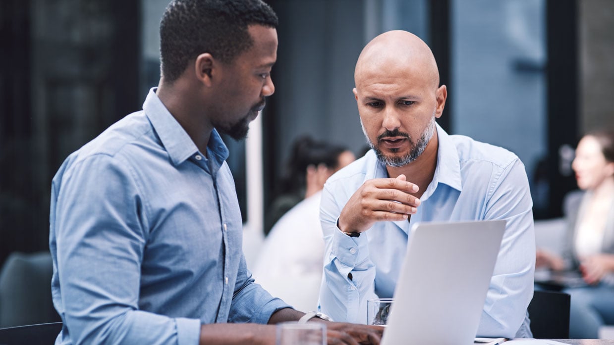 men outside working laptop